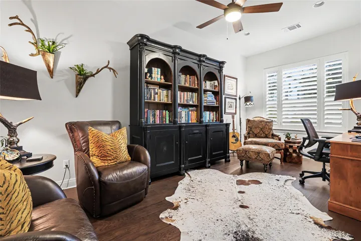 Gleaming hardwood floors and classic wood shutters define this versatile home study.