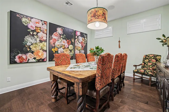 Warm hardwood floors complement a spacious setting designed for formal dining and entertaining.