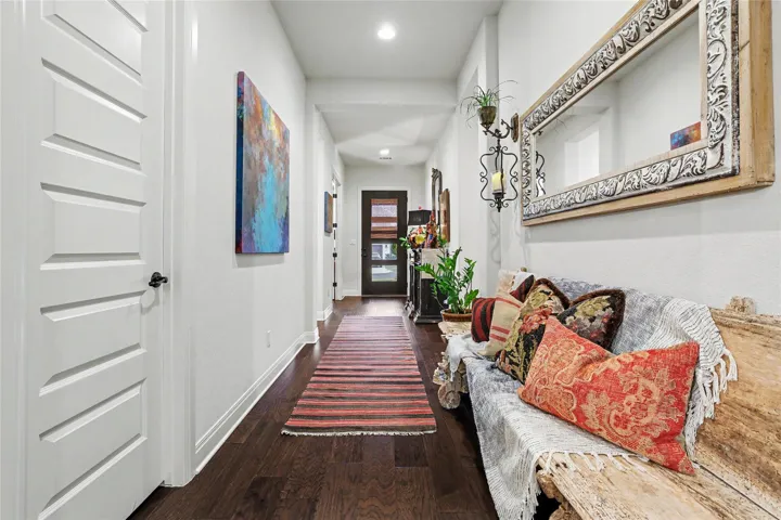 Rich hardwood floors lead down a long hallway.