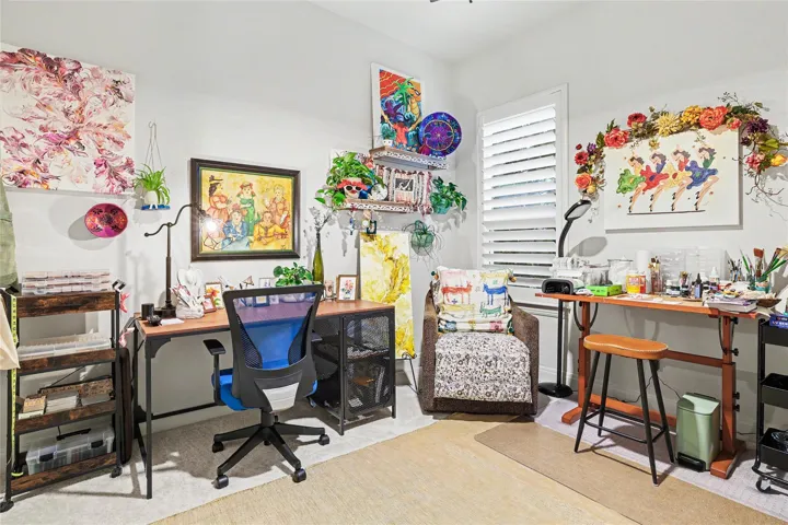 Natural light streams through plantation shutters to illuminate this versatile home workspace.