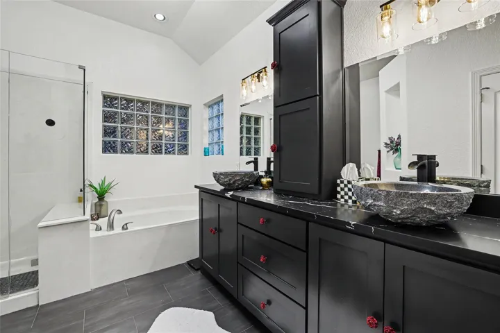 All of the cabinets in this room were removed and replaced with new cabinets.  The center cabinet is designed to be a linen closet.  The above counter bowl sinks are gorgeous.  All plumbing was re-designed in this area and new lighting fixtures added...