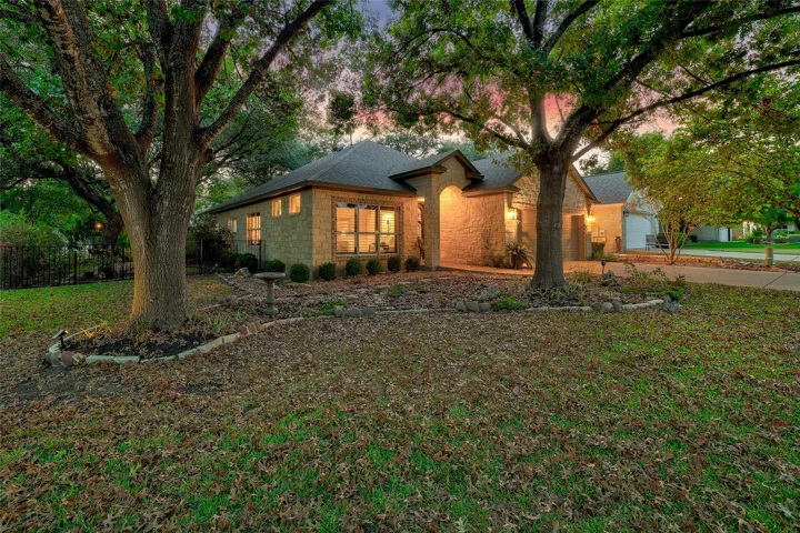 A side angle photo of the front of the home at twilight...