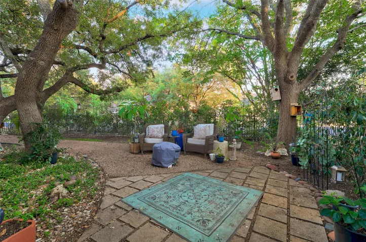 The back yard is fenced in with wrought iron fencing, extra concrete block patio area with outdoor lighting.  Crushed granite in other areas plus so many fresh plants added for privacy & beauty...