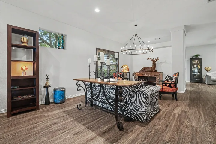 Current owners took this area that was actually intended to be another dining area & made it into a very comfortable sitting area.  This large circular light fixture was added.  Of course, this area could still be a great dining area with a great double window to the landscaped side yard...