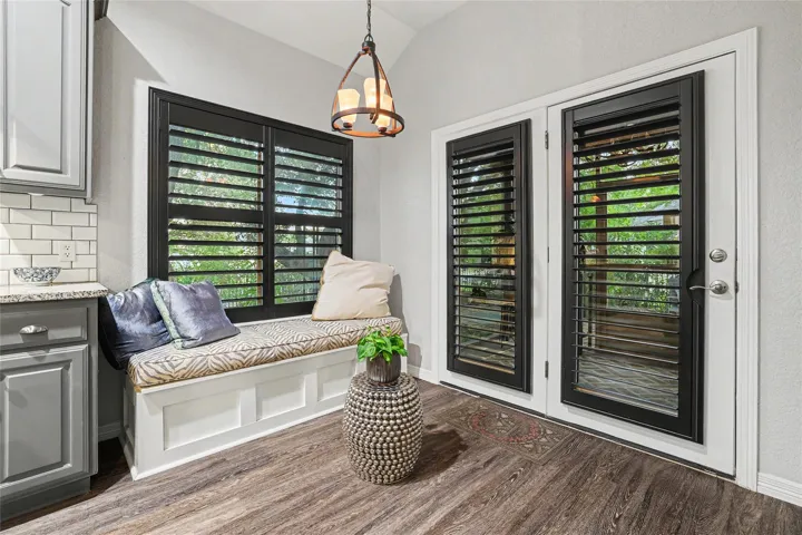 The bench area here is free standing & perhaps negotiable.  Sellers had it built as a reading area.  This area is actually the breakfast room....Again, gorgeous black Plantation Shutters on the double window and the door to the screened in patio...