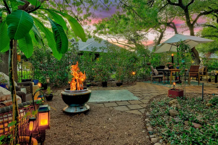 Great shrubbery added around all of the wrought iron fence for privacy and peace.  Make this your paradise....day or night...