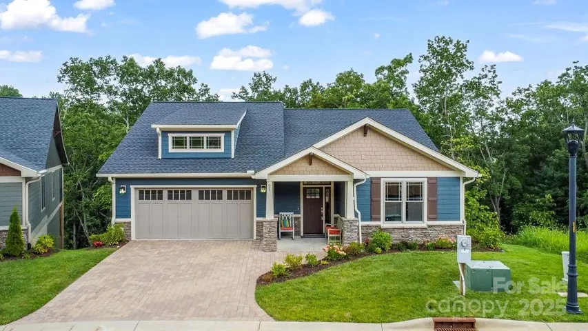 Beautiful Craftsman construction with stone paver driveway