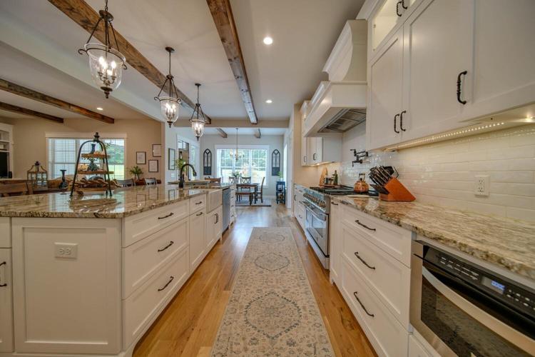 This Kitchen is a Chef's dream! 6 burner gas stove, built in drawer microwave, an over sized Island and walk in pantry