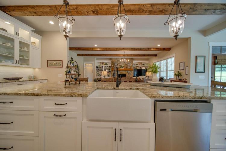 The wooden beams throughout the main living area give the farmhouse a "french provincial"  look