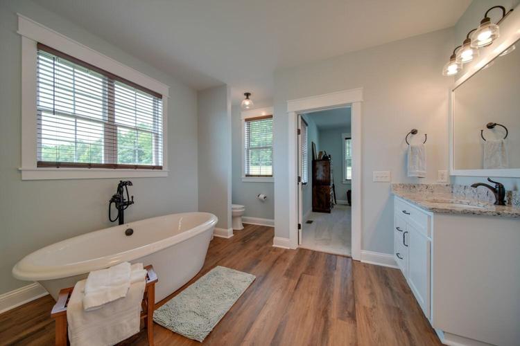 Luxurious owners bath with free standing soaking tub, walk in shower and large walk in closet