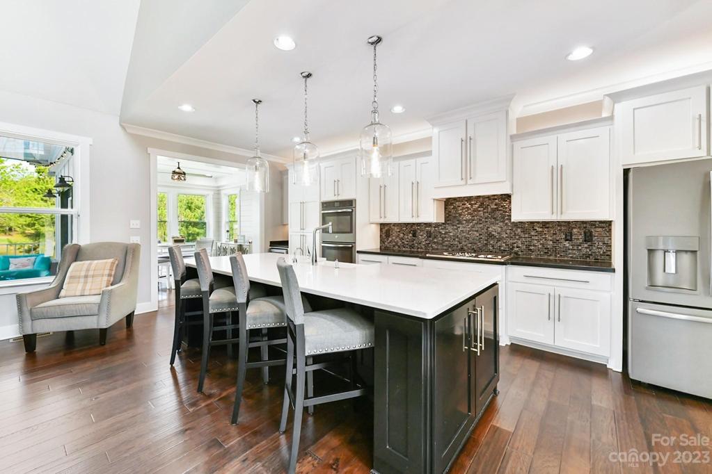 Wood floors, Craftsman Custom Cabinets, and Designer Tile Backsplash
