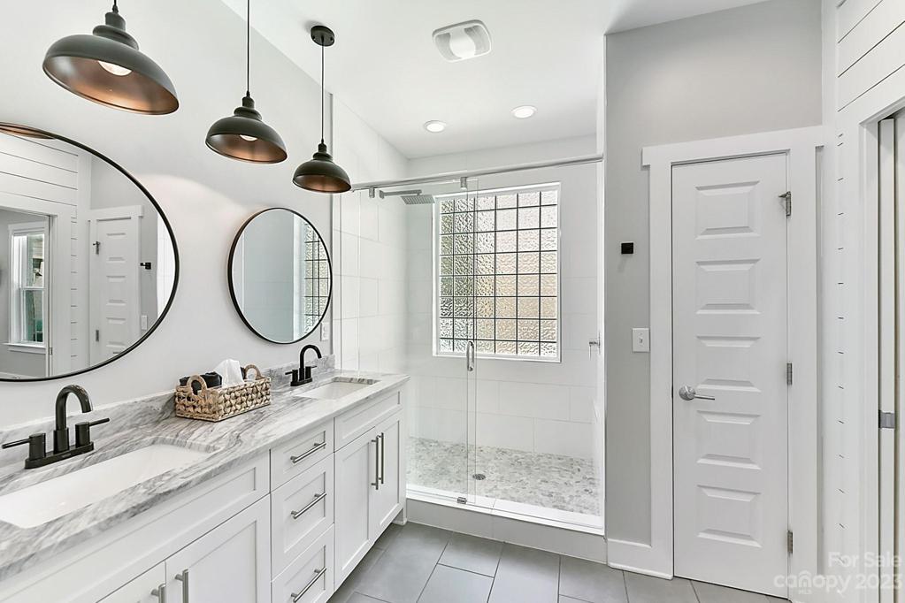 Fabulous Bath with Frameless Shower with Pebble Flooring Design