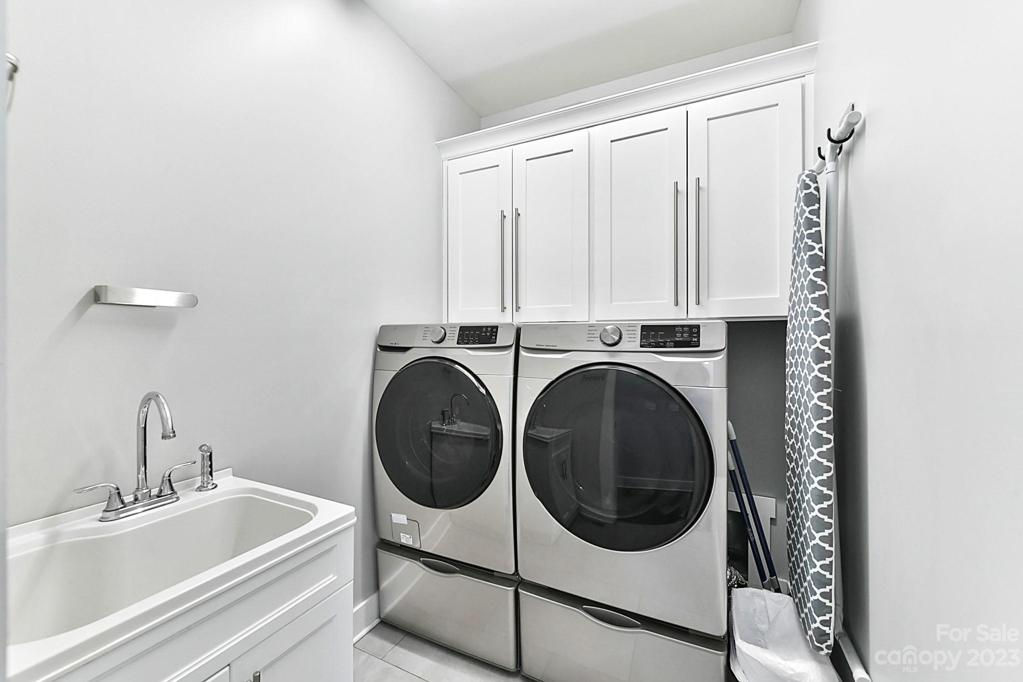 Laundry has Cabinets, Utility Sink, Tiled Floors