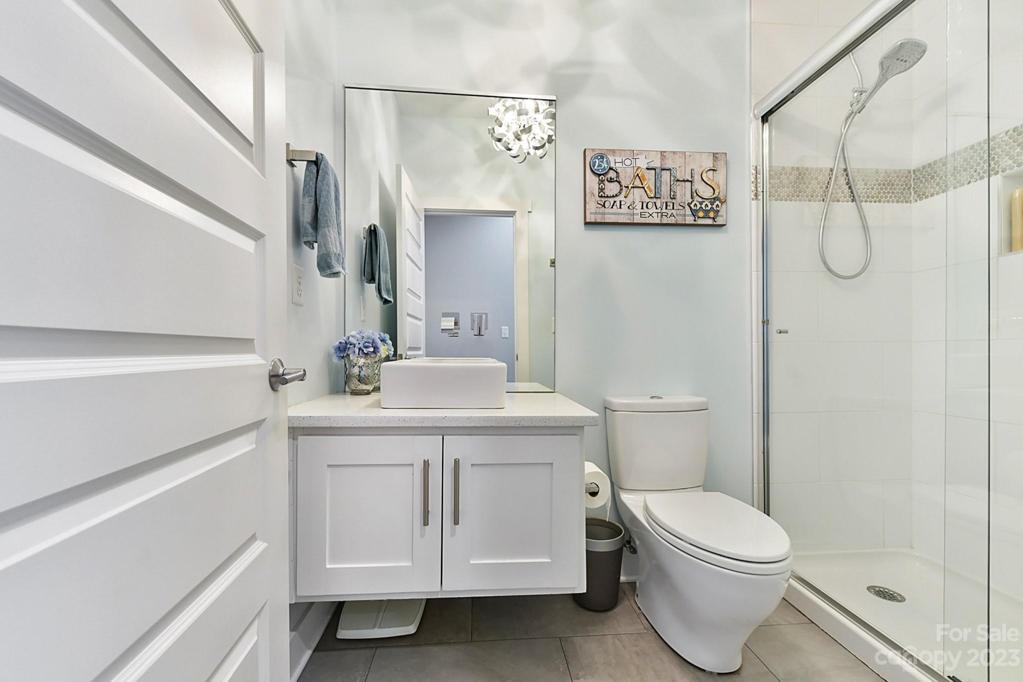Full Bath on Main with Shower and Floating Cabinet. Tiled Flooring
