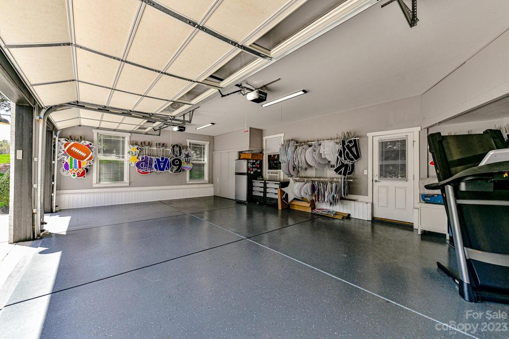 Immaculate 3 Car Garage with Storage and Epoxy Floors