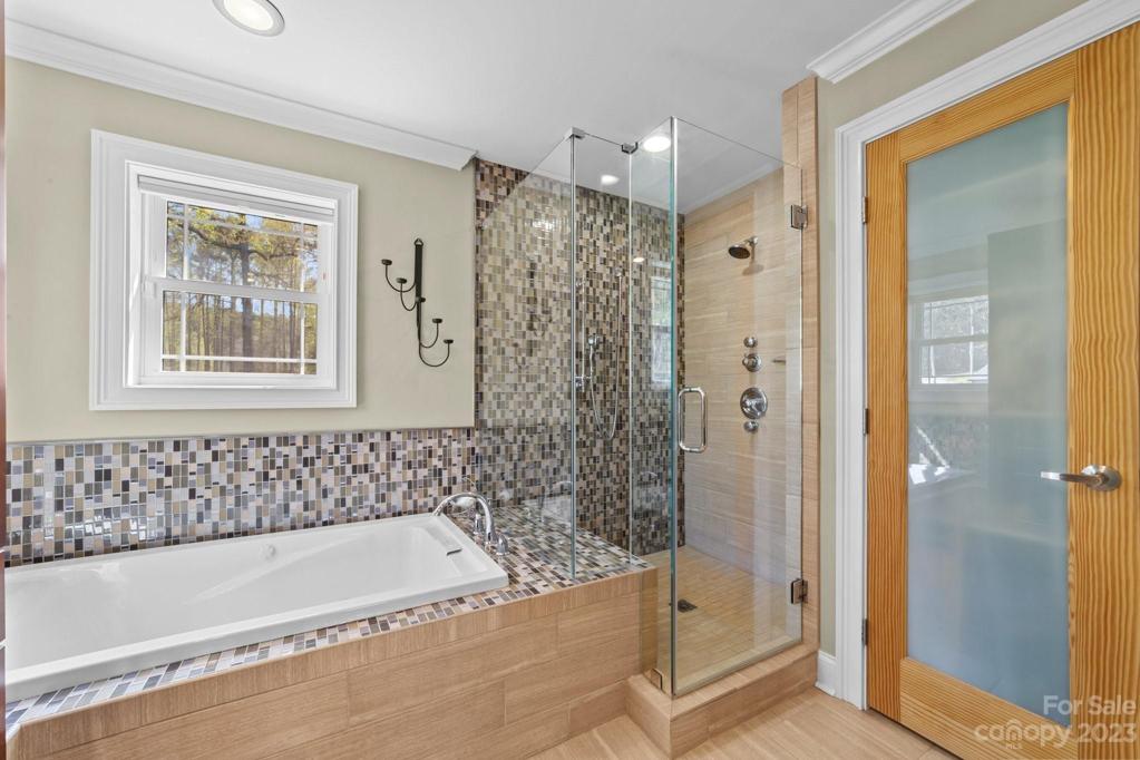 Frameless shower with oversized tub