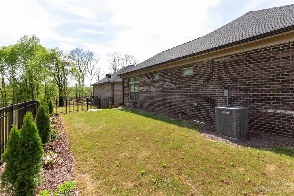 Fenced backyard with additional privacy landscaping installed.