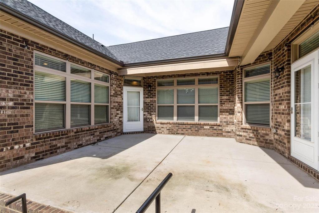 Private patio features a retractable awning with wind sensor.