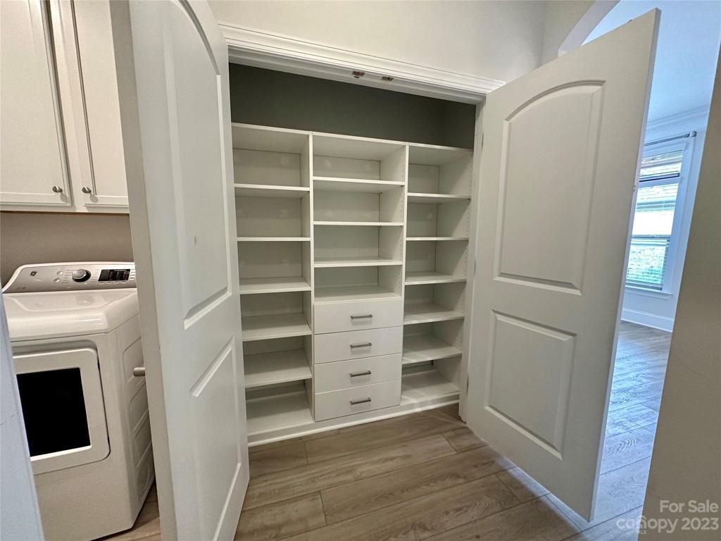 Amazing pantry off of the kitchen with custom built in shelving.