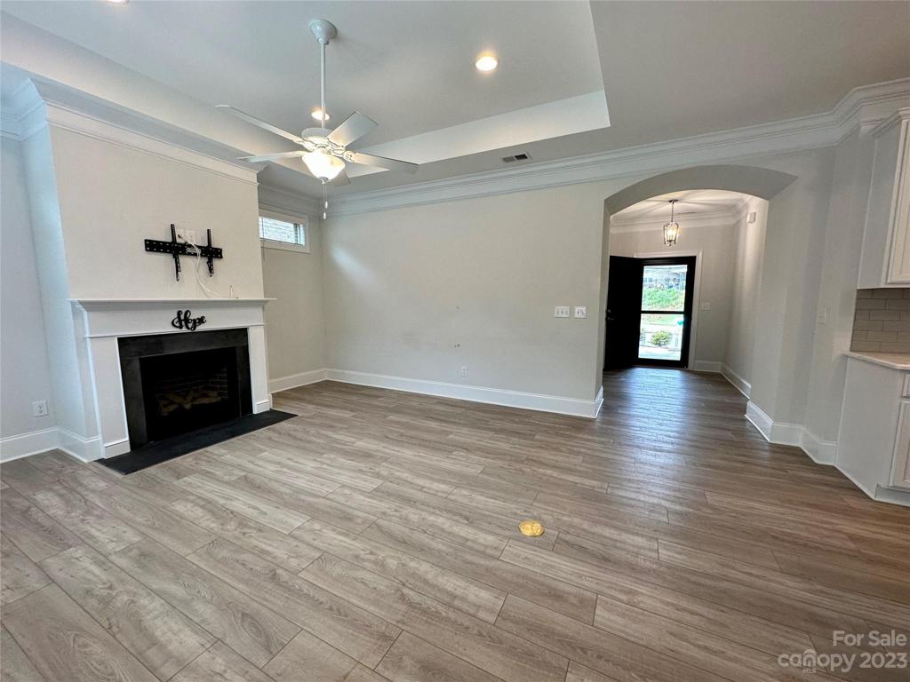 Living room with trey ceilings, and gas log fireplace. . . Opens to the kitchen