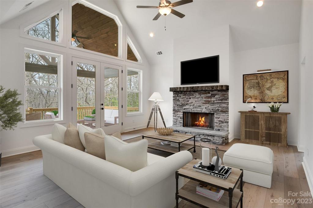 Great room with cathedral ceilings and a stone wood burning fireplace