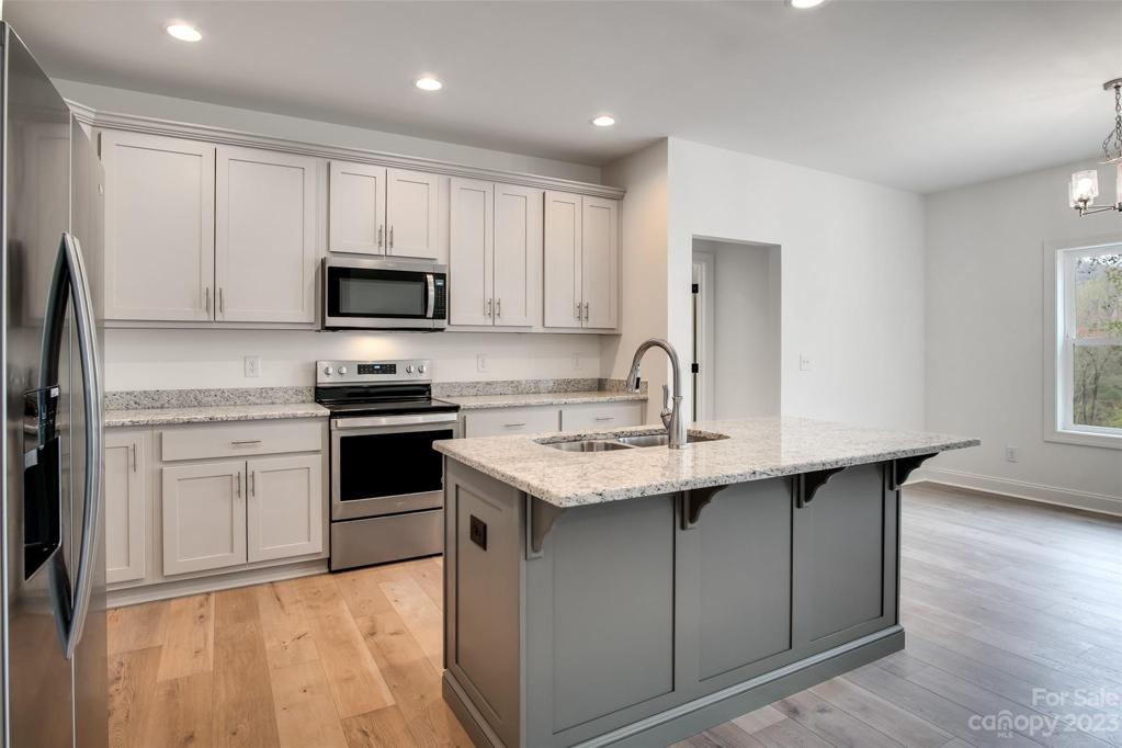 Granite counter tops and stainless steel appliances.