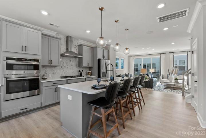 Structural options include: first floor guest suite, storage at second floor, tray ceiling, modern fireplace, sliding glass door to outdoor living and gourmet kitchen.