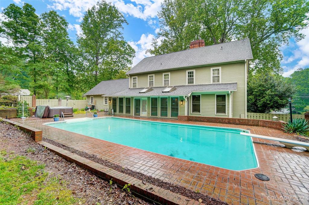 Welcome home to your oasis! Why start with a picture of the front on the home when you will be spending all your time out back enjoying this magnificent back yard with a massive in-ground pool, hot tub and plenty of brick patio pavers to soak up the sun on.