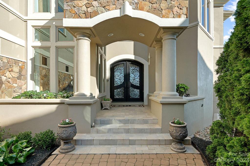Oversized wrought iron double door welcomes you home
