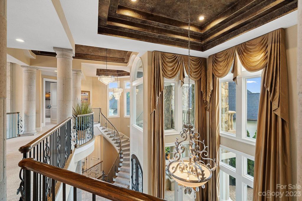 3rd story walkway with ornamental iron balusters to upper level