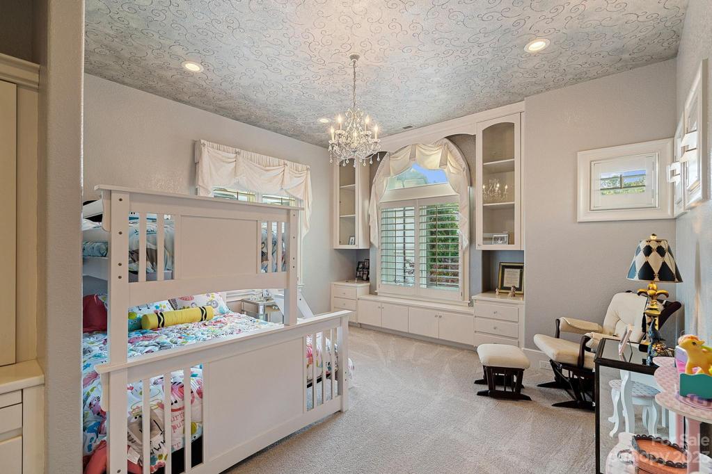 Handprinted with crystal accents, private bath, glass built in and walk in closet makes this a true princesses room