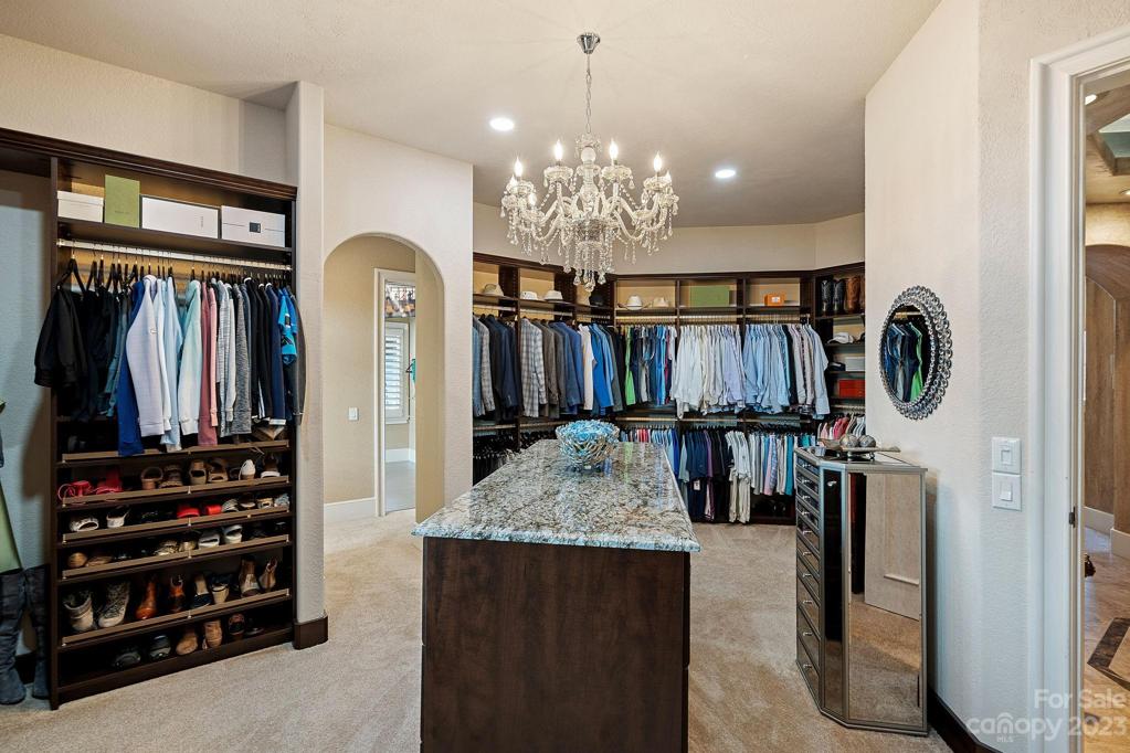 Brand new custom closet features oversized island and built in makeup table