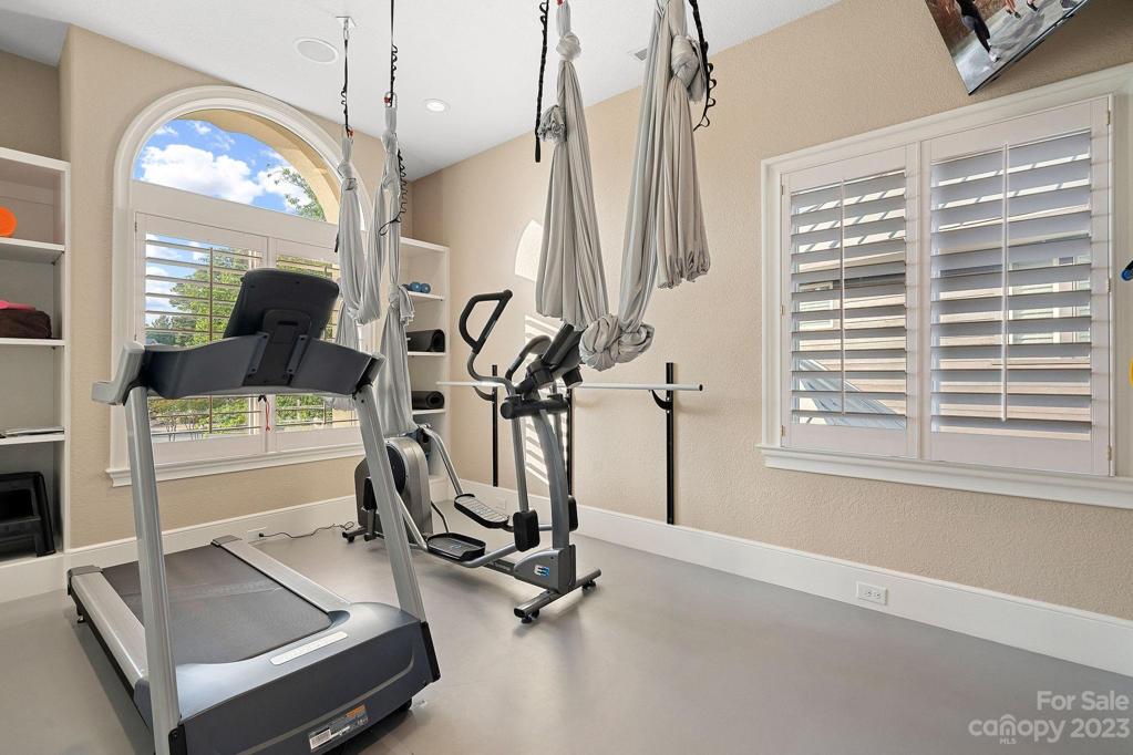 Gym equipped with flying yoga equipment and ballet barre