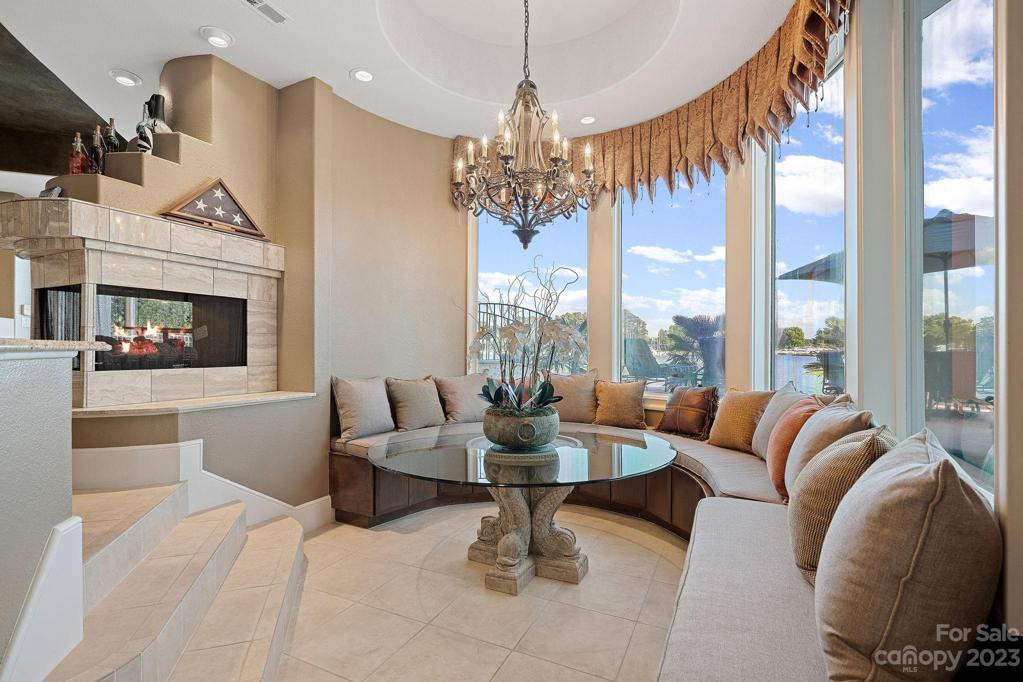 Circular sitting area with built in bench accentuates curved glass window