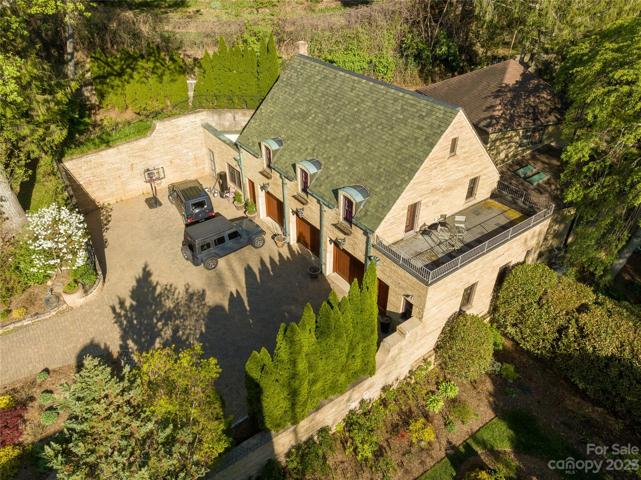 A two bedroom guest suite/apartment with an open air deck overlooking the courtyard terrace rests above that 3 bay garage