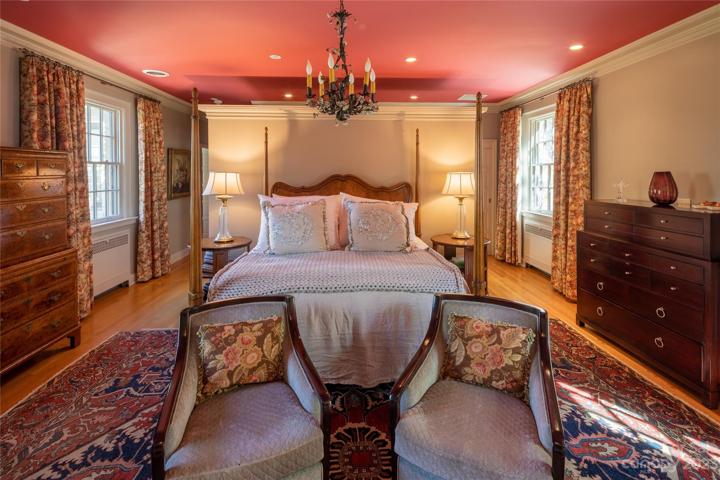 The primary suite provides views of the gardens as well as views of the cozy primary suite's romantic fireplace (not shown in this photo)!