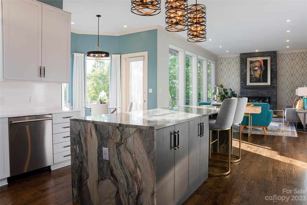 This full kitchen remodel is bright and light and rich with quartzite, a full suite of Monogram appliances and mixed metal fixtures...