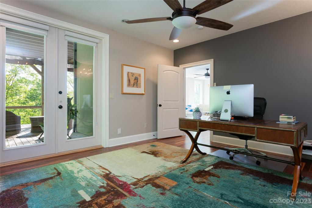 Basement office with private doors leading to a lovely seating area on the deck.  Could make an incredible guest suite!