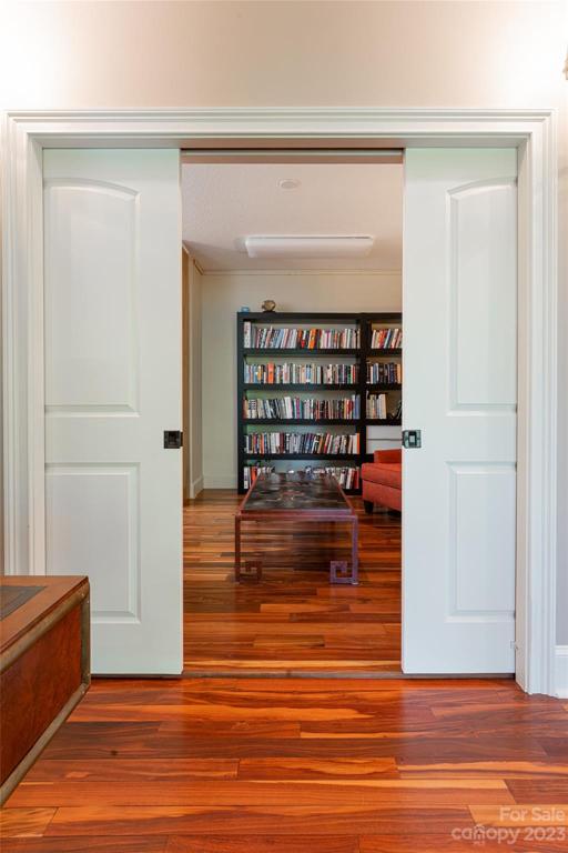 Sliding doors reveal an additional sitting room off the office on the basement level...