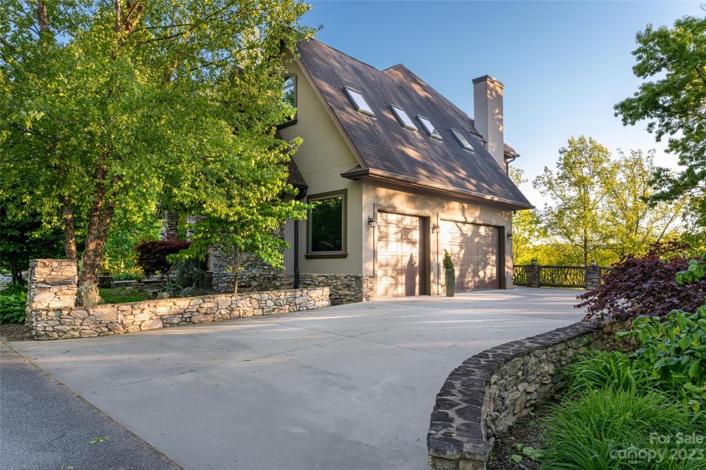 A stunning raised drive leads to a 3-car garage!