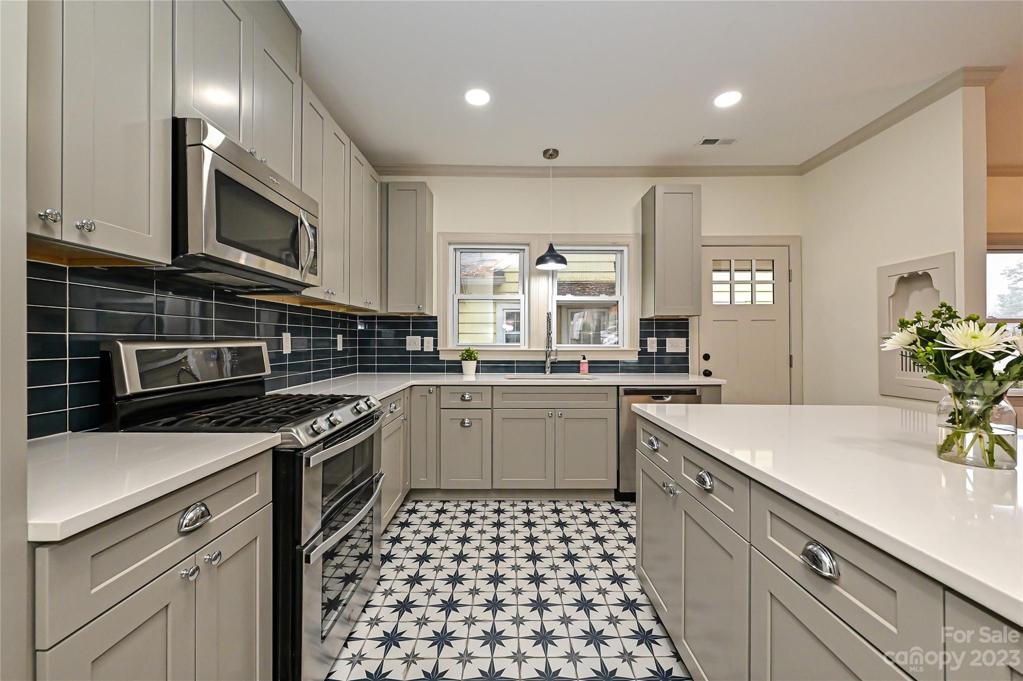 Kitchen with stainless steel, gas range, recessed lighting
