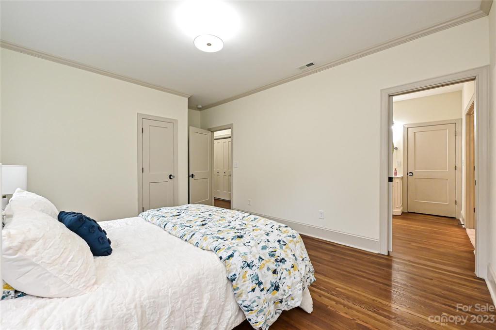 Pocket door to en suite primary bath leaves extra wallspace and easy access