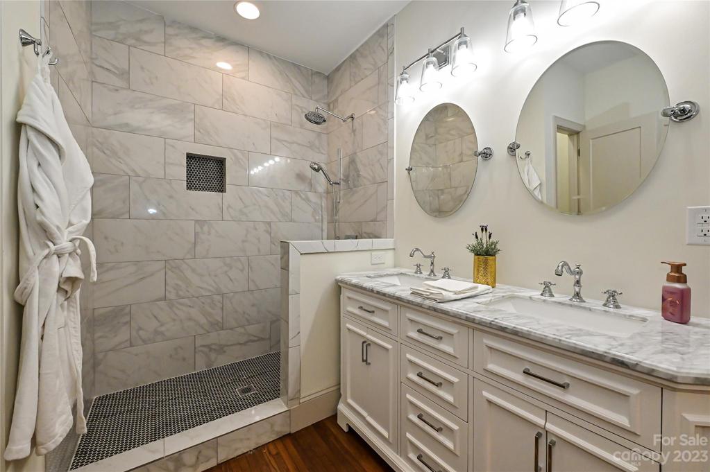 Dual vanity and floor to ceiling tiled shower