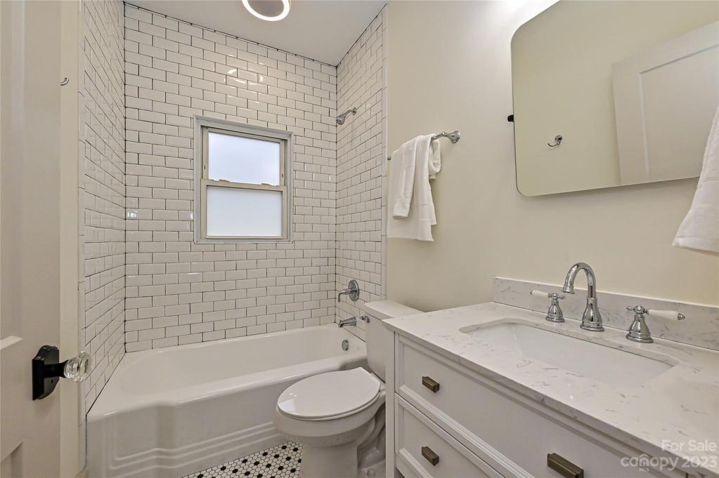 Full bath with subway tile and cast iron tub, black & white penny tile floor AND bluetooth speaker for your listening pleasure