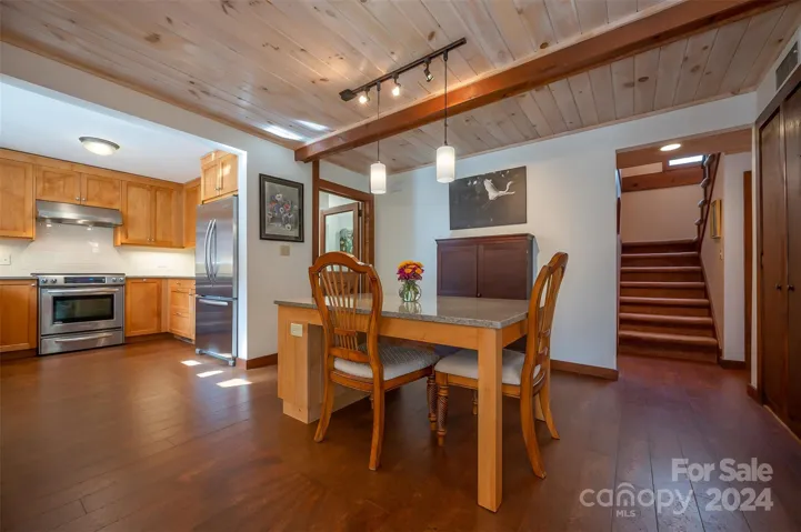 Dining island with stairs to the right and kitchen to the left.