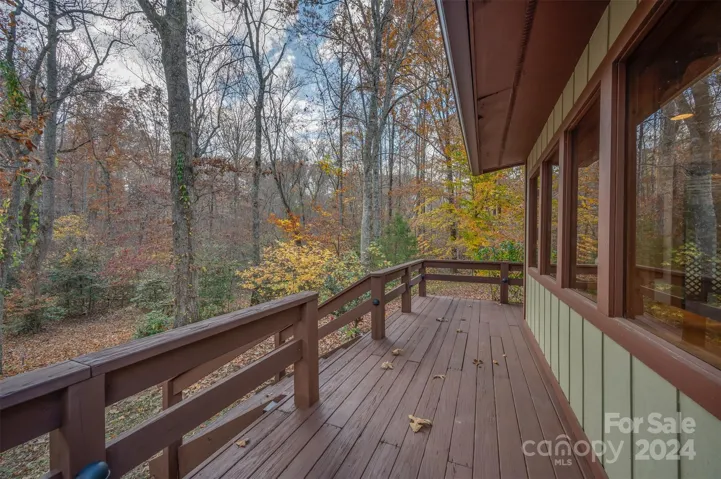 Continuation of the deck leads to the backyard and creek.