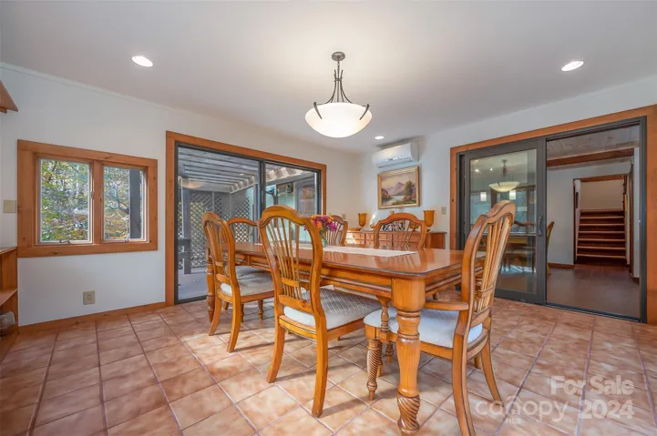 Sunroom/dining room has sliding glass doors leading to outdoor spaces.