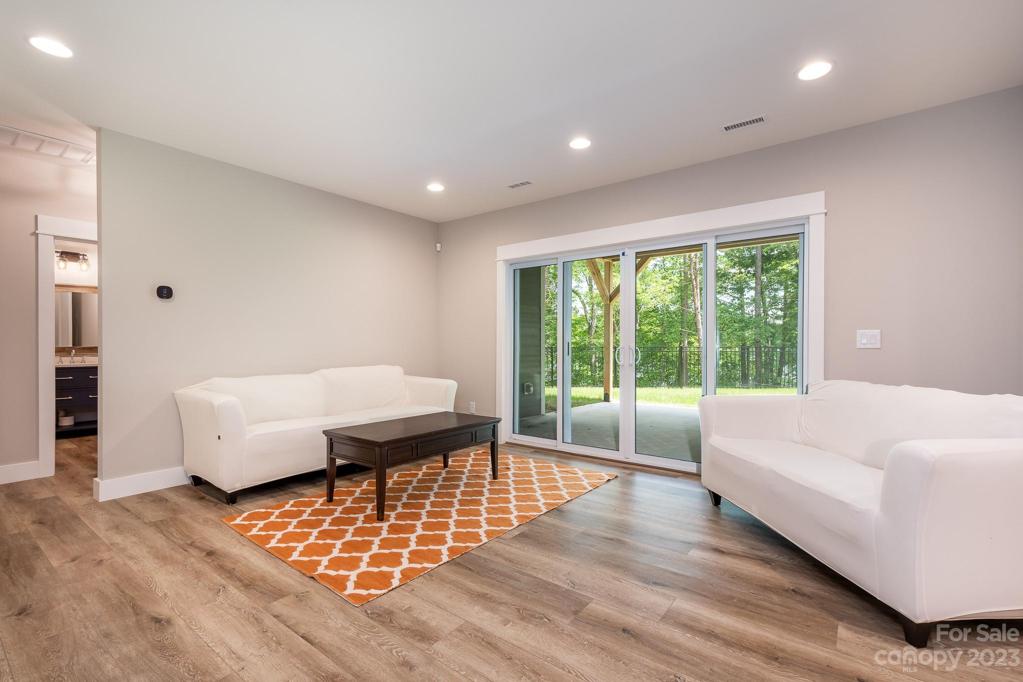 Basement living area with sliding doors to covered patio