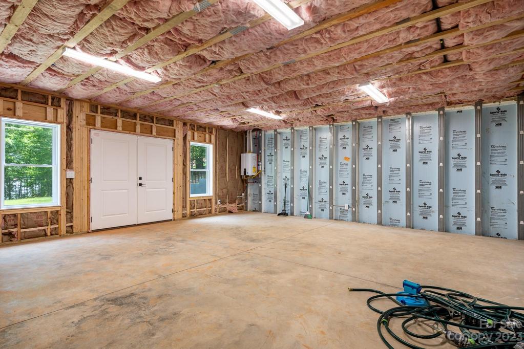 Large storage area with double doors to cement pad