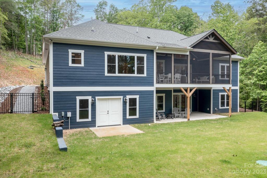 Back of home with doors to storage area